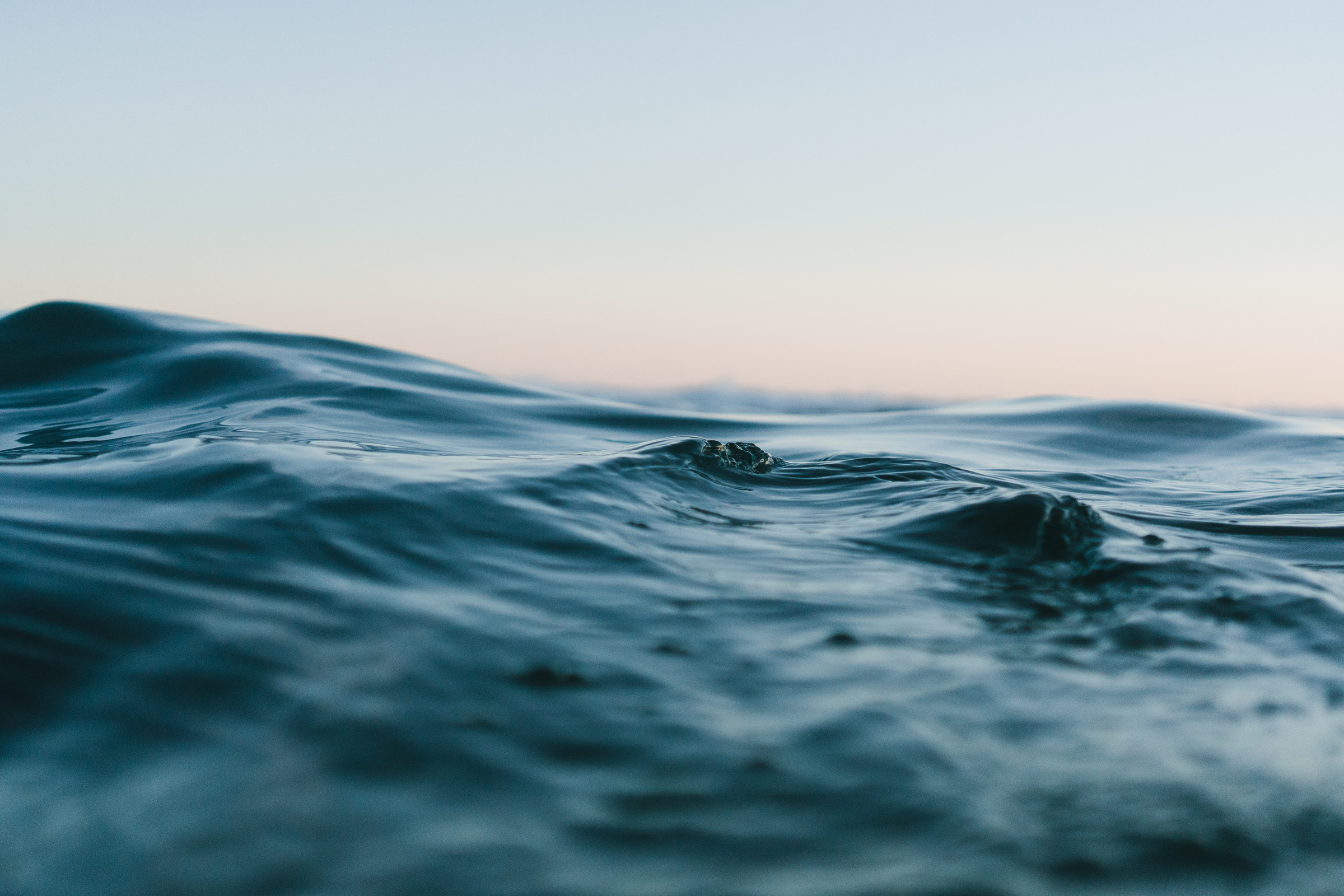 Body of Water Under Blue and White Skies